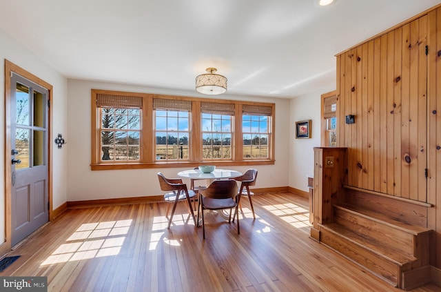 dining area with baseboards, visible vents, and light wood-style floors