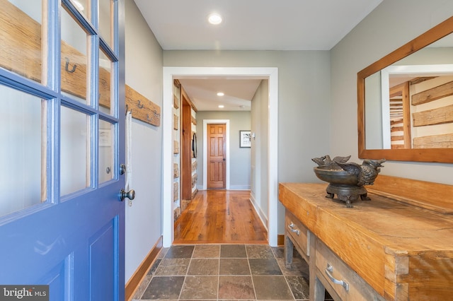 interior space with recessed lighting, stone finish flooring, and baseboards