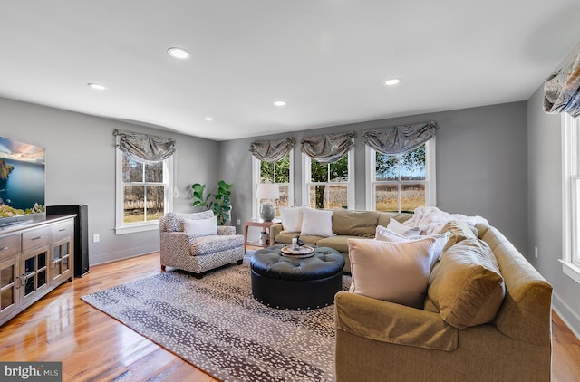 living room with light wood-style flooring, baseboards, and recessed lighting