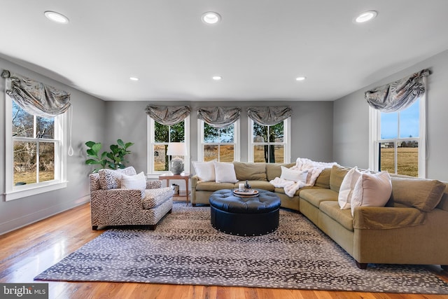 living area with a wealth of natural light, recessed lighting, and wood finished floors