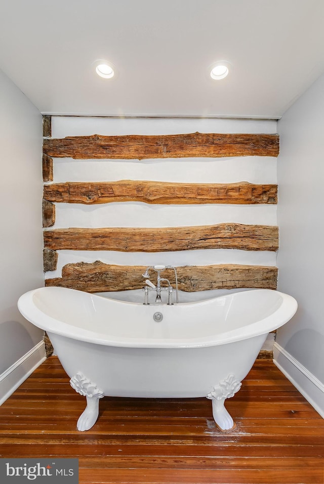 full bath featuring a soaking tub, wood finished floors, and recessed lighting