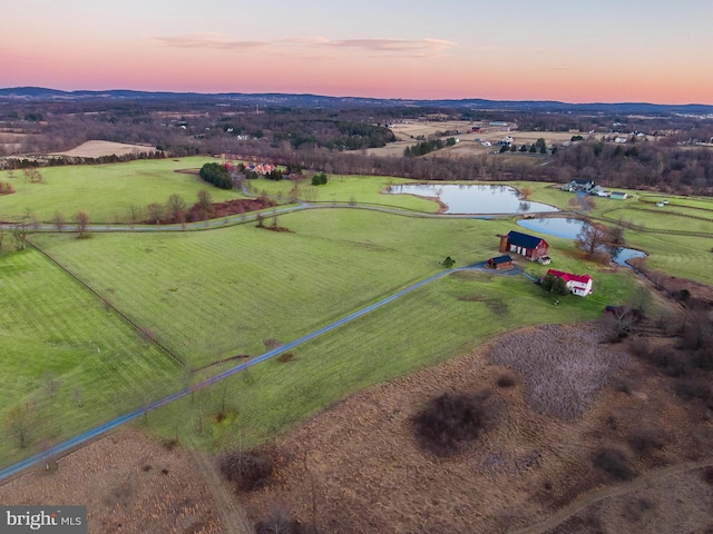 birds eye view of property with a rural view and a water view