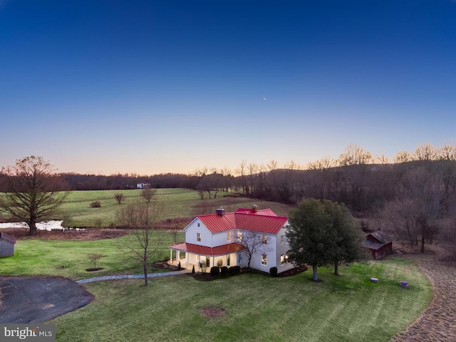 birds eye view of property with a rural view