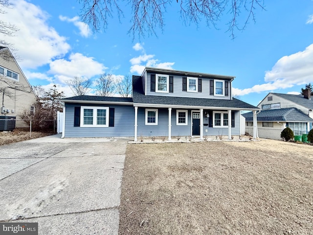 view of front of home with a shingled roof, fence, driveway, and central air condition unit