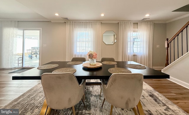 dining room with recessed lighting, wood finished floors, visible vents, stairway, and crown molding