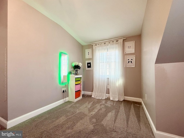 game room featuring lofted ceiling, baseboards, and dark colored carpet