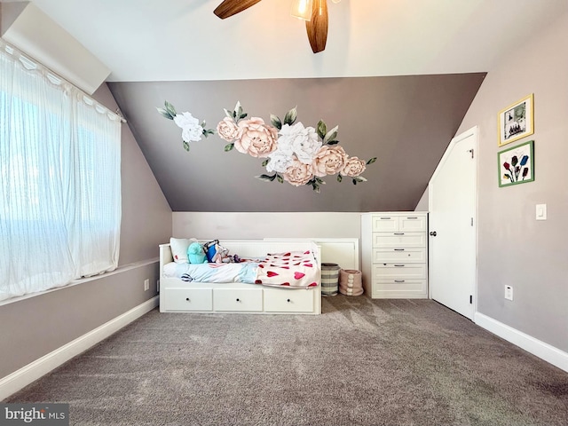 unfurnished bedroom featuring ceiling fan, carpet, baseboards, and vaulted ceiling