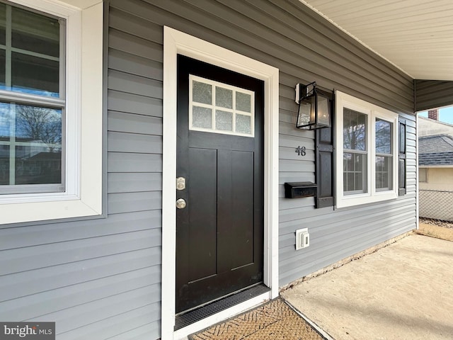 view of exterior entry featuring covered porch