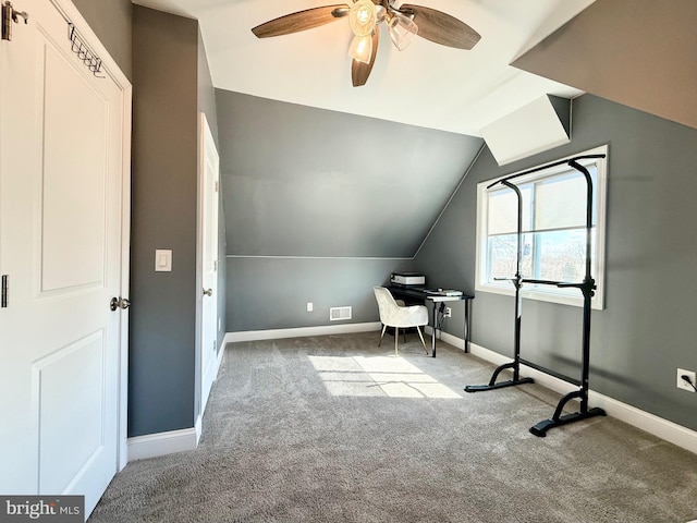 unfurnished office featuring carpet, lofted ceiling, visible vents, ceiling fan, and baseboards