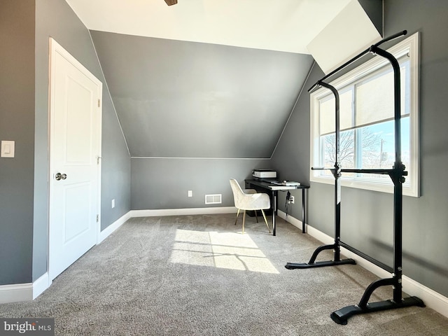 unfurnished office featuring baseboards, visible vents, and vaulted ceiling