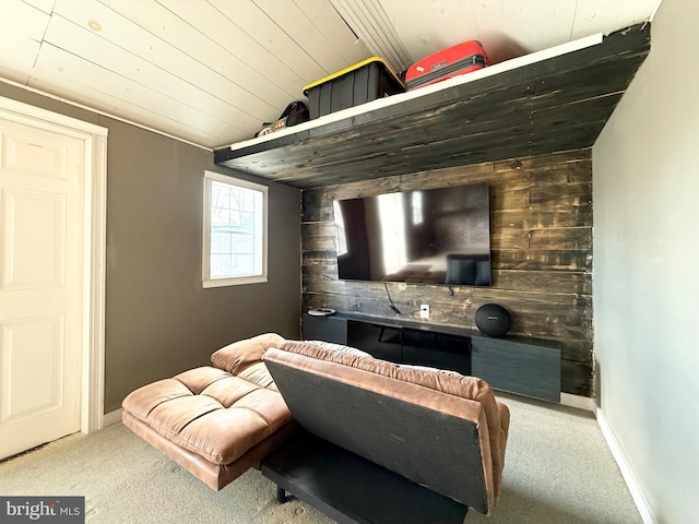 interior space featuring wooden walls, baseboards, wooden ceiling, an accent wall, and vaulted ceiling