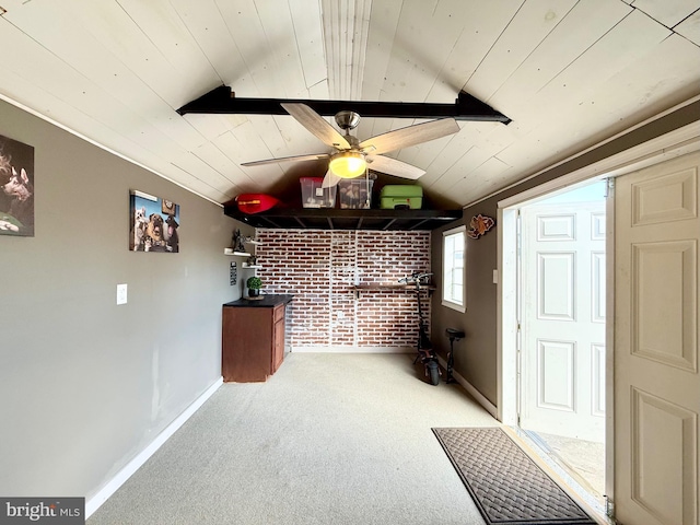 bar featuring lofted ceiling, ceiling fan, wooden ceiling, light colored carpet, and brick wall