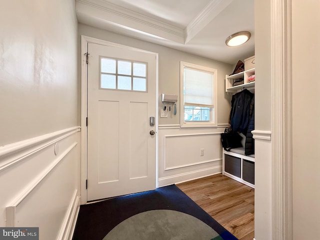 mudroom with a wainscoted wall, a decorative wall, crown molding, and wood finished floors