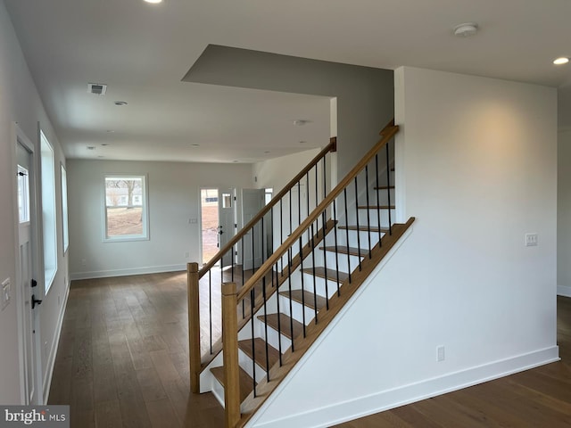 stairs featuring baseboards, visible vents, wood finished floors, and recessed lighting