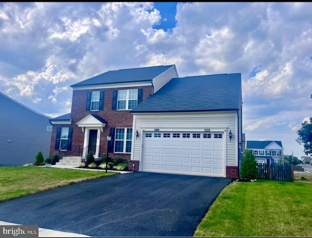 view of front of property with an attached garage, a front yard, aphalt driveway, and brick siding