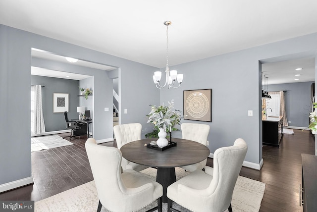 dining room with dark wood-style floors, an inviting chandelier, and baseboards