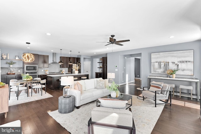 living room featuring dark wood finished floors, recessed lighting, baseboards, and a ceiling fan