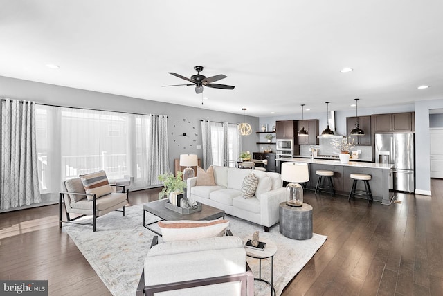 living area featuring recessed lighting, dark wood-style floors, and a ceiling fan