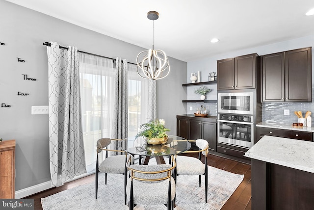 dining space with dark wood finished floors, a notable chandelier, recessed lighting, and baseboards