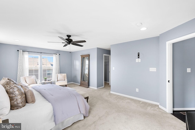 bedroom with a walk in closet, baseboards, ceiling fan, light colored carpet, and recessed lighting