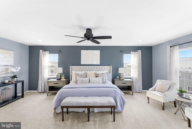 bedroom with recessed lighting, multiple windows, light colored carpet, and baseboards