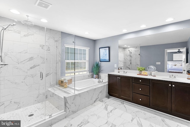 ensuite bathroom featuring a bath, visible vents, a marble finish shower, and a sink