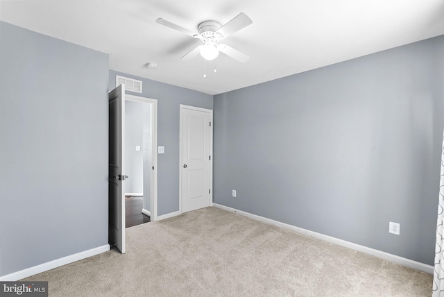 unfurnished bedroom with visible vents, a ceiling fan, baseboards, and carpet floors