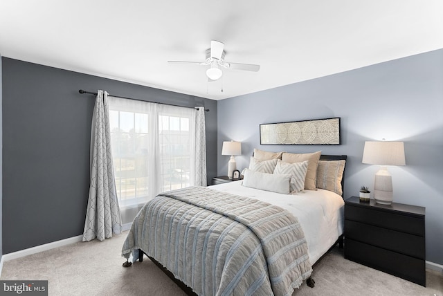 carpeted bedroom featuring baseboards and ceiling fan