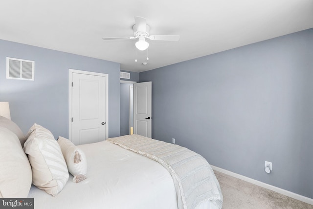 bedroom featuring a ceiling fan, baseboards, visible vents, and light carpet