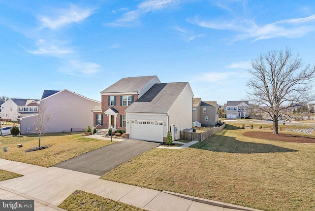 view of front of property with a residential view, a garage, driveway, and a front yard