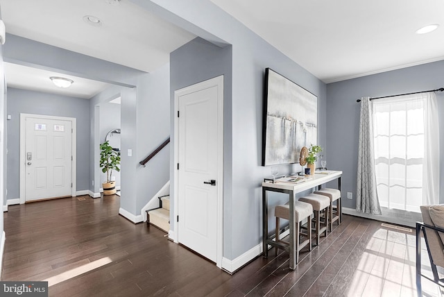 foyer featuring stairway, recessed lighting, baseboards, and wood finished floors