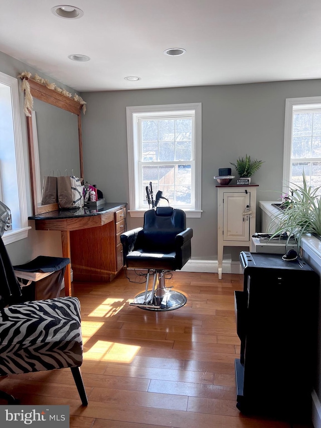 living area featuring light wood finished floors, baseboards, and recessed lighting