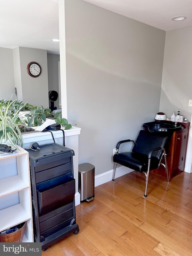 living area with light wood-style floors and baseboards