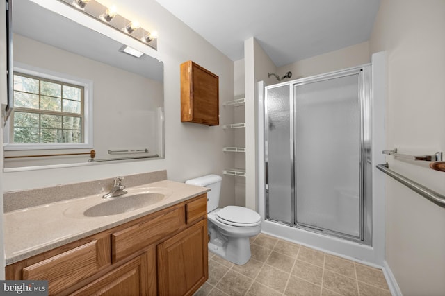 bathroom featuring toilet, a shower stall, and vanity