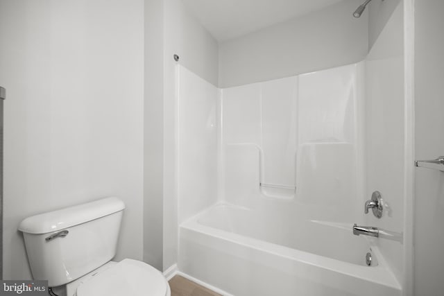 bathroom with washtub / shower combination and toilet