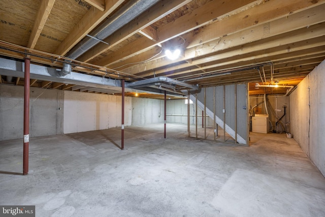 unfinished basement featuring washer / clothes dryer