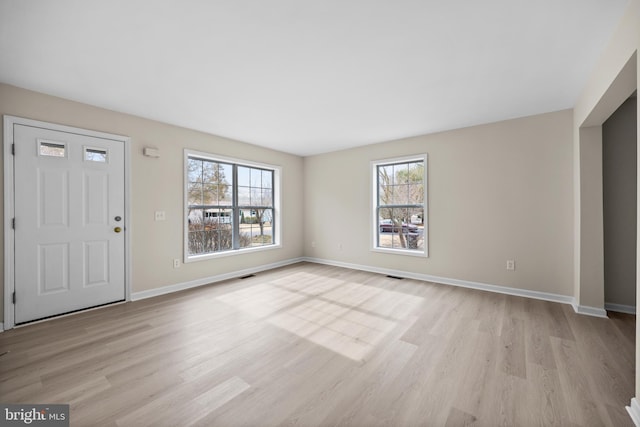 entrance foyer featuring visible vents, light wood-style flooring, and baseboards