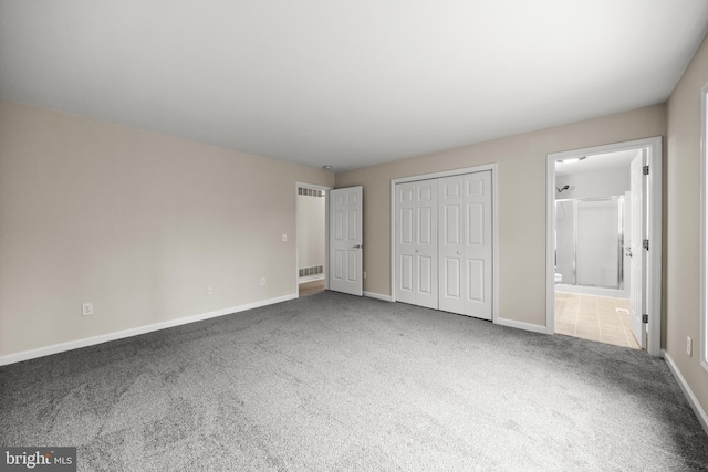 unfurnished bedroom featuring carpet flooring, visible vents, and baseboards