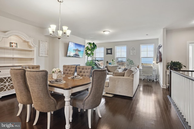 dining room featuring an inviting chandelier and dark wood finished floors