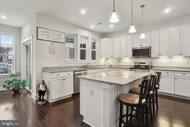 kitchen featuring white cabinetry, dark wood-style floors, and appliances with stainless steel finishes