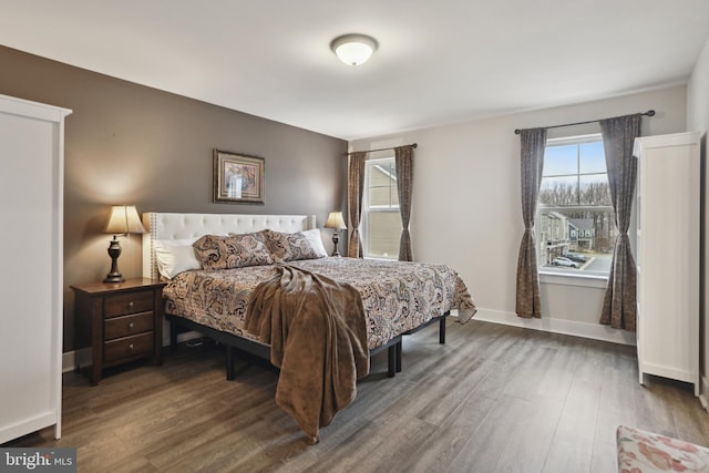 bedroom featuring baseboards and wood finished floors