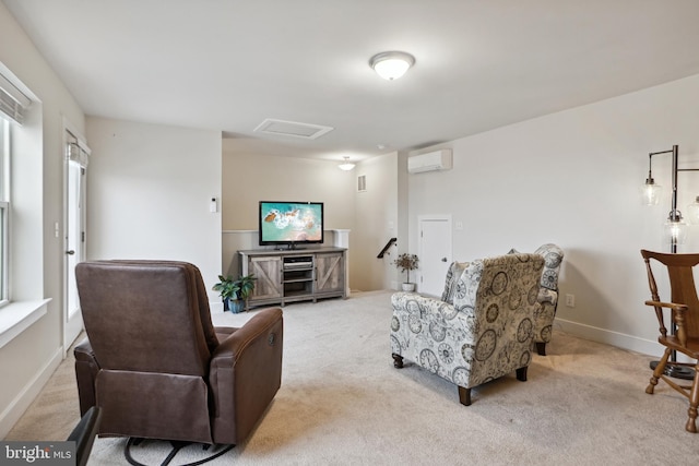 living room with baseboards, light colored carpet, attic access, and a wall unit AC