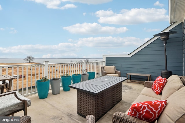 view of patio with a water view and an outdoor hangout area