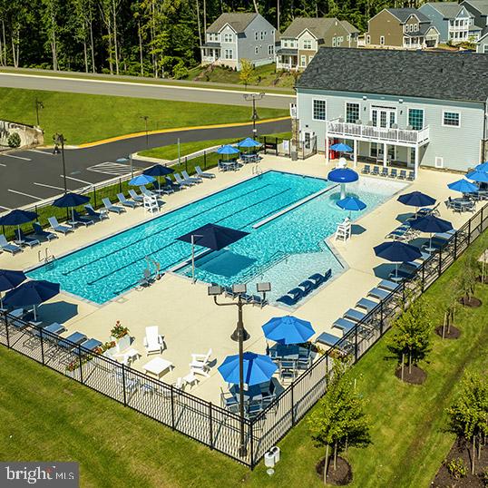 pool with a patio and fence