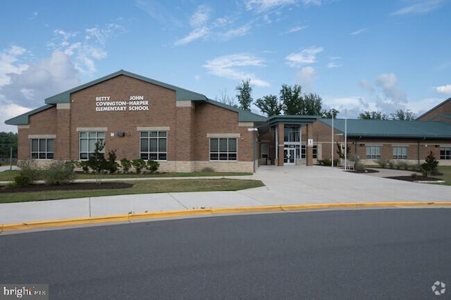 view of front facade featuring brick siding and driveway