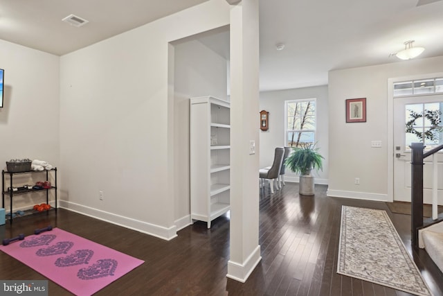 entrance foyer featuring visible vents, baseboards, and dark wood-style flooring