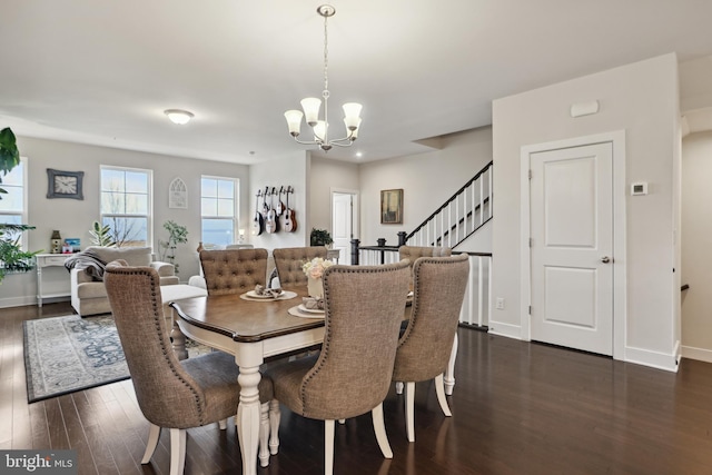 dining space with a chandelier, stairs, dark wood-type flooring, and baseboards