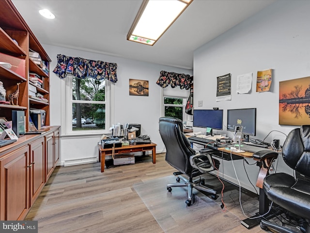 office space with a baseboard radiator and light wood finished floors