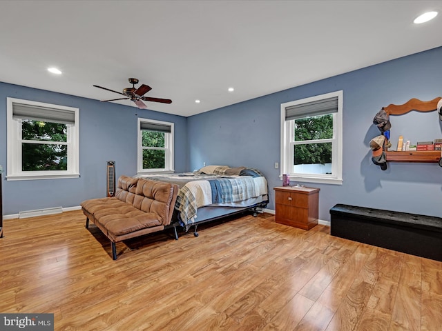 bedroom featuring light wood-style flooring, multiple windows, and visible vents