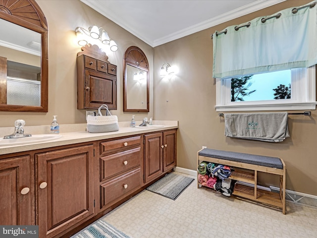 bathroom featuring double vanity, crown molding, and a sink